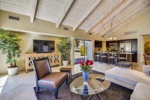 a living room with a couch and a table at Elegant Lakeside Villa in Rancho Mirage