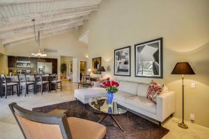 a living room with a couch and a table at Elegant Lakeside Villa in Rancho Mirage +20 photos