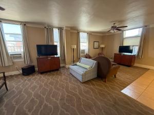 a living room with a couch and a tv at The Gadsden Hotel in Douglas