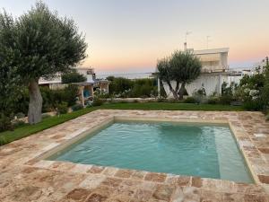 a swimming pool in the backyard of a house at Brezza sul Mare in Polignano a Mare +12 photos