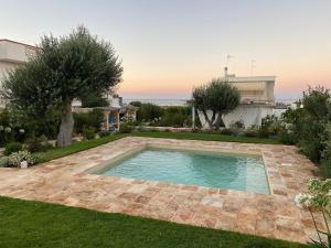 a swimming pool in the yard of a house at Brezza sul Mare in Polignano a Mare