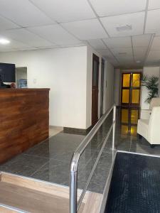 a lobby with a staircase in a building with a couch at Hotel Olavarria in Olavarría