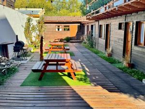 a row of picnic tables on a patio at Apart Las Carretas in El Calafate