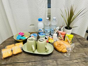 a table with a plate of food and bottles of water at B&B Gelso Rosso Pompei in Pompei