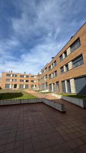 a large brick building with a bench in front of it at Apartamentos Suites Iscar in Iscar