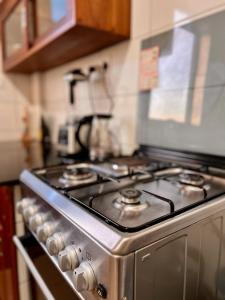 a stainless steel stove top oven in a kitchen at CITY Que2ens in Arusha
