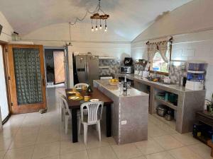 a large kitchen with a table and chairs in it at Casa Brisamar in Caleta Grau