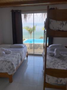 a bedroom with two bunk beds and a view of the ocean at Casa Brisamar in Caleta Grau +23 photos