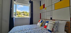 a bedroom with a bed with a large window at Aparthouse with pool in Solin +28 photos