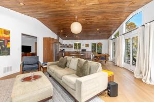 a living room with a couch and a table at How you Dune in Saugatuck