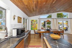 a kitchen with a table and a dining room at How you Dune in Saugatuck