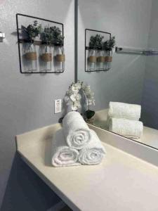 a bathroom with towels on a counter in front of a mirror at October Deal Only 97 Dollars 3-Bedroom Family Condo, Pool & More - Just 12 Mins to Disney! Cortile in Kissimmee