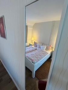 a bedroom with a bed and a mirror at Haus Sonnenschein in Zingst in Zingst