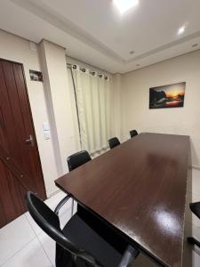 a conference room with a wooden table and chairs at Angra Praia Hotel in Fortaleza +35 photos