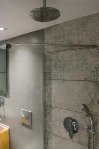 a shower with a glass door in a bathroom at villa eri in Kalamákion