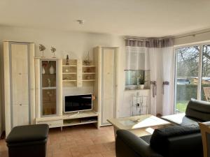 a living room with a couch and a tv at Ferienwohnung in Mirow for 4 Personen in Mirow