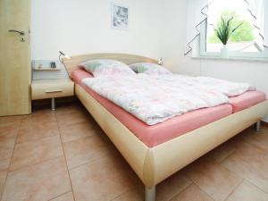 a small bed in a room with a window at Ferienwohnung in Mirow for 4 Personen in Mirow