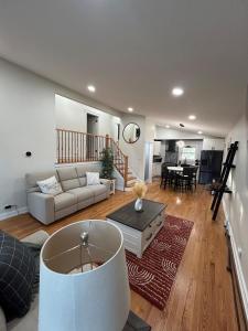 a living room with a couch and a table at RR Oasis in Des Plaines