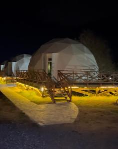 a night view of a building with a tent at Chadir yurd glamp in İsmayıllı