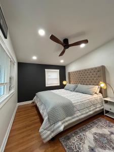 a bedroom with a bed with a ceiling fan at RR Oasis in Des Plaines