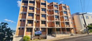 a tall brick building on the side of a street at Hotel LF by Feliciano Joaçaba in Joaçaba