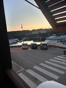 a group of cars parked in a parking lot at Casa dei bagnanti sul Porto Vecchio in Stintino
