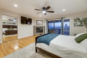 ein Schlafzimmer mit einem Bett und einem Kamin in der Unterkunft Cincinnati Home, Patio with Downtown Views! in Cincinnati
