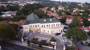 an aerial view of a large white building with cars parked at Hotel Mirador Plaza in San Salvador