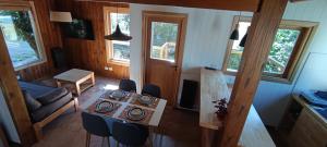 a living room with a table and chairs in a house at Cabaña las Frutillas in San Martín de los Andes +12 photos