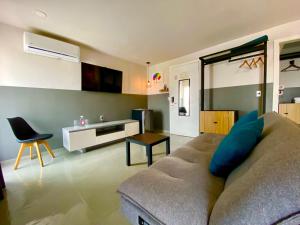 a living room with a couch and a table at Hotel NEXT Guadalajara in Guadalajara