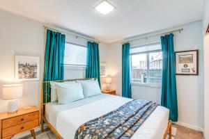 a bedroom with a bed and a window with blue curtains at Close to Downtown and Parks Modern Anchorage Home in Anchorage