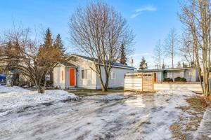 a house with a driveway in the snow at Close to Downtown and Parks Modern Anchorage Home in Anchorage