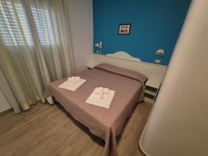 Postel nebo postele na pokoji v ubytování Hotel REX