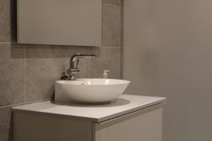 a white sink on top of a counter in a bathroom at New apartment, parking, close to city and nature in Stockholm +4 photos