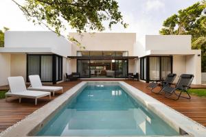 a villa with a swimming pool and a house at ¡Increible! Villa Luz de Luna in Akumal