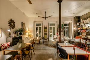 a restaurant with tables and chairs and a room filled with tables at Casa das Janelas com Vista in Lisbon