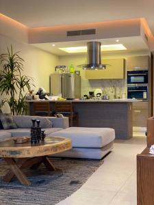 a living room with a couch and a table at Peninsula Nuevo Vallarta in Mezcales
