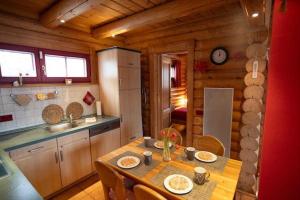 a kitchen with a table in a wooden cabin at HyggeZeit-im-Holzblockhaus-in-Wernigerode in Wernigerode