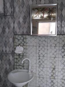a bathroom with a sink and a mirror at Hostel Baladi in Socorro
