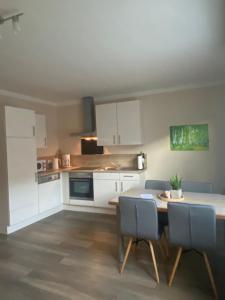 a kitchen and dining room with a table and chairs at Ferienwohnung Ambiente II und III in Klotten
