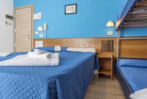 Postel nebo postele na pokoji v ubytování Hotel REX