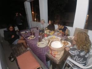 a group of people sitting around a table eating food at TableMountain CityHub in Cape Town +2 photos