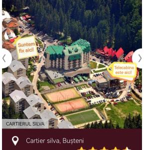 an aerial view of a building in a city at 2 rooms apartment Telecabinei Busteni in Buşteni