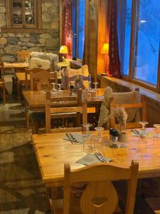 a group of wooden tables in a restaurant at Chalet Alpina résidence Val Claret in Tignes