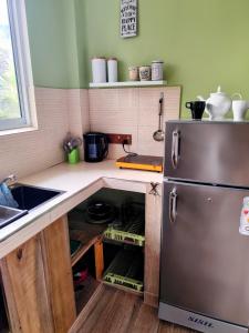 a kitchen with a sink and a refrigerator at Green Eyes Villa in Habaraduwa Central