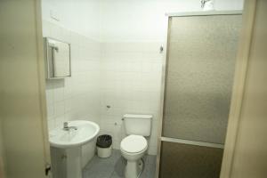 a small bathroom with a toilet and a sink at Hotel Virginia in Linhares +31 photos