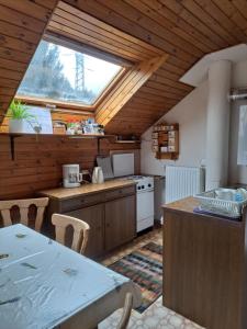 a kitchen with a table and a large window at Apartment Fam. Zappe in Steinhaus am Semmering