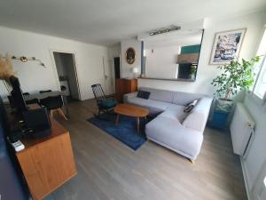 a living room with a couch and a table at Spacious 1 bedroom apartment near Paris in Garches