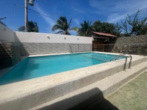 a swimming pool in front of a house at Cabaña Don Jerónimo in Santa Verónica