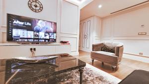 a living room with a tv and a chair at 2bedroom apartment and condo at Taksim with free parking in Istanbul